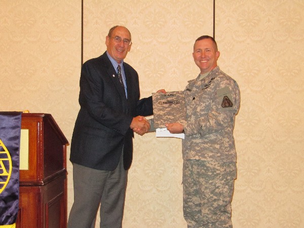 Col. Fred Eisele, USA (Ret.), chapter vice president for programs, presents a chapter memento to Lt. Col. Johnny Powers, USA, Program Executive Office of Simulation, Training and Instrumentation, following the colonel's presentation at the November meeting.